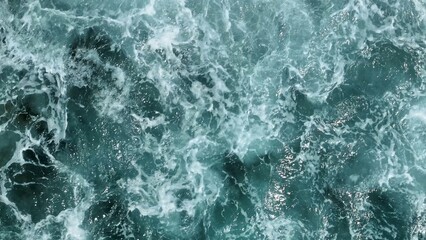 Naklejka premium An aerial view highlights the epic power of the ocean, with massive waves breaking over the rocky shore, each crash a spectacular force of nature. Thailand. 