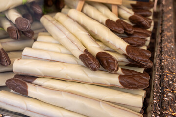 Chocolate vegetables made of different types of chocolate by hand in a candy shop for the spring season chocolate asparagus