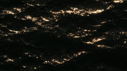 The serene wave patterns on the sea's surface shimmer with sunlight, as the slow-motion footage...