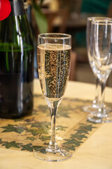 Pouring and tasting of dry sparkling wine brut, grand reserve, champagne in Ay-Champagne wine making village in Vallee de la Marne, , Champagne region, France