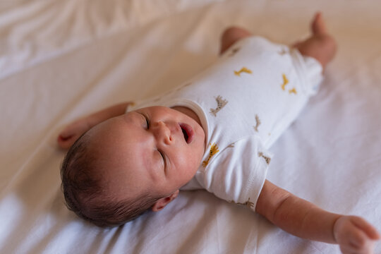 Cute newborn on bed