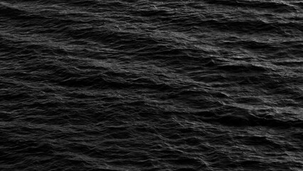 A captivating black and white image of sea waves in motion, where the dynamic flow of the water creates a powerful visual, showcasing the raw energy and beauty of the ocean's movement.

