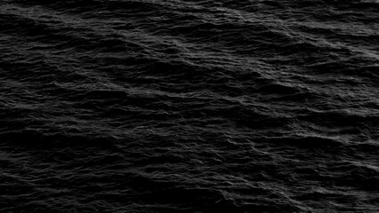 The monochrome sea waves in motion reflect the power and serenity of the ocean, with light and shadow playing across the water's surface, creating a dramatic yet peaceful scene of nature.
