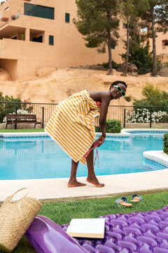 Woman changing clothes near pool