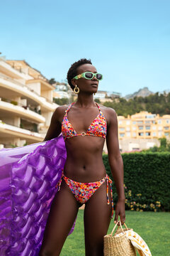 Young beautiful woman at poolside looking for a place to settle