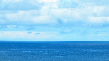 A captivating aerial shot of the open ocean, featuring calm, rippling blue waters under a clear sky, perfect for serene, natural, and water-themed content. Phuket, Thailand.
