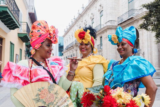 Cuban women called canasteras with habano flowers and typical costume in La Havana, Afro caribbean people in Latin America	