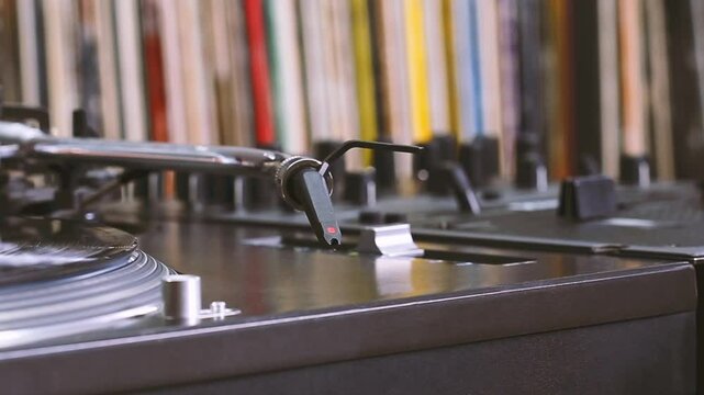 DJ headshell on spinning turntable. Listening the music on vinyl. Closeup