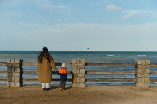 mother and son looking at the sea from the observation deck