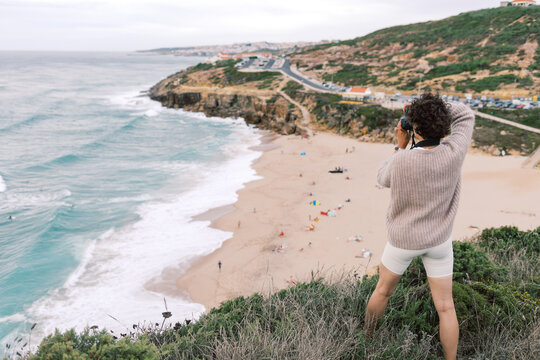 Photographer Overlooking S&atilde;o Juli&atilde;o Beach in Ericeira