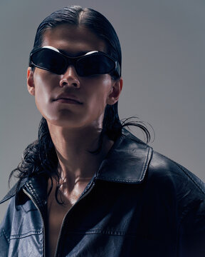 Stylish male model poses dramatically in sunglasses