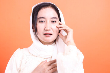 Portrait of a serene woman wearing a hijab, radiating peacefulness and cultural grace, isolated on...