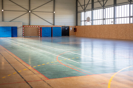 Empty Indoor Sports Hall with Basketball Hoop and Goal