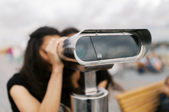 Two Women Looking Through Binoculars at Scenic View