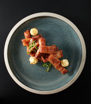 Closeup of garlic fried pork ribs on a plate