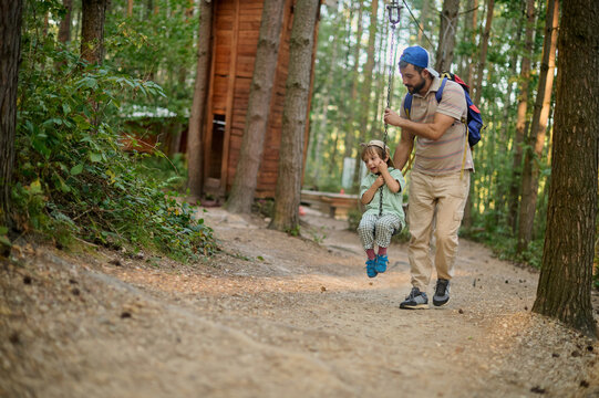 family on a forest zip line