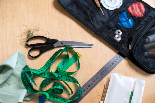 Sewing tools and materials on a wooden table