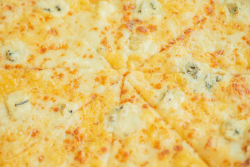Four cheese pizza as a background macro photo.
