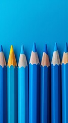 Vibrant Colored Pencils Arranged in a Row Against a Blue Background Perfect for Creative Projects and School Supplies
