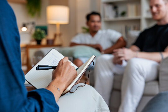 Midsection of female therapist is writing in diary