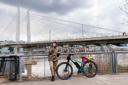 standing next to bike  