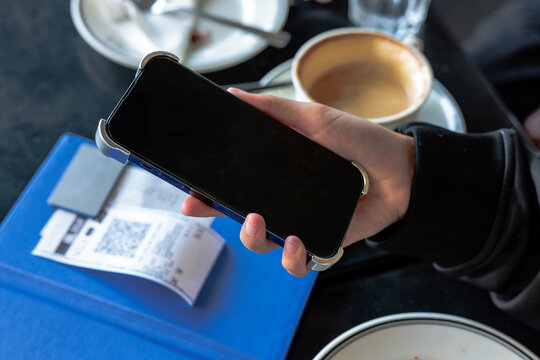 Closeup shot of hand doing online payment through smartphone