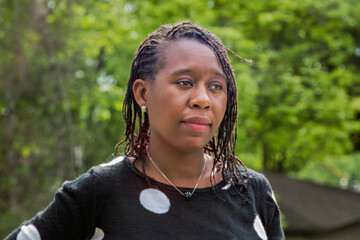 Smiling African Woman with Braided Hair in Green Park Portrait