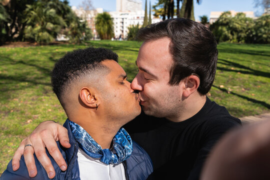 Gay couple kissing in a park