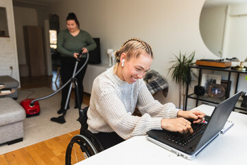 Woman in Wheelchair Working on Laptop at Home