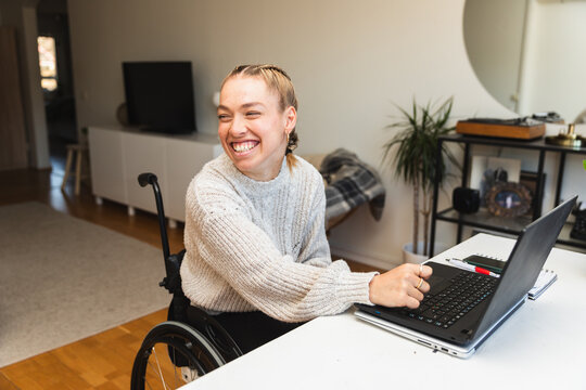 Woman in Wheelchair Working on Laptop at Home
