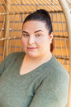 Portrait of a Brunette Woman with Ponytail in a Relaxed Setting