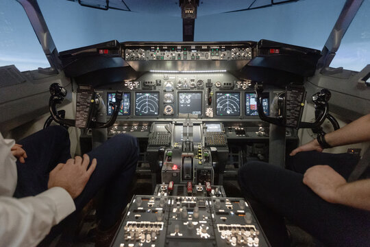 Pilots operating aircraft from cockpit at night
