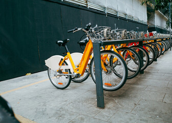 Row of many bicycles for rent parked in the street of Milan
