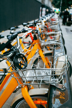 Side view of many bicycles at bike sharing parking lot in town