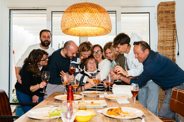 Happy family celebrating with grandma and a boston terrier dog