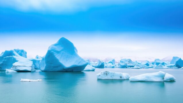 Icy blue toned landscape of icebergs floating on calm waters