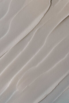 Swatch of smooth face cream makeup texture on a neutral background