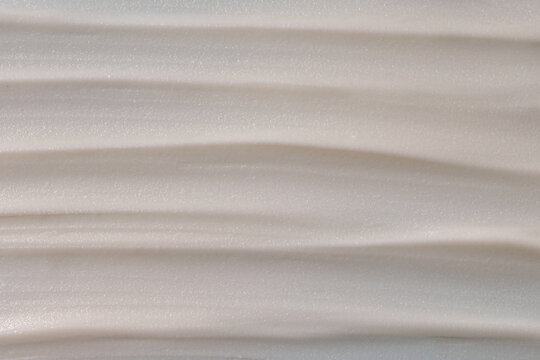 Smooth face cream texture swatch showcasing soft shine