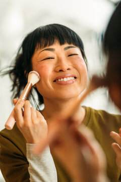 Woman applying makeup