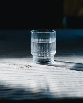 Textured Glass of Water in Dramatic Light