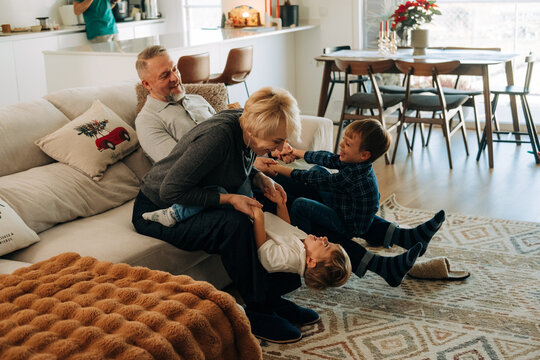 Happy Grandparents Playing with Kids in the Living Room