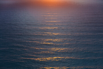 Vast ocean waves at sunset