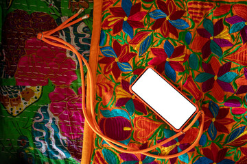 A smartphone on a colourful blanket 