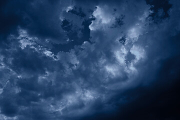 Black blue gray evening night sky with clouds. Dark dramatic cloudy sky background. Light. Before...