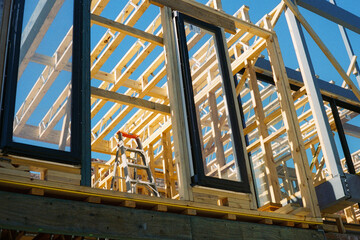 Film photo of a wooden frame construction under blue skies