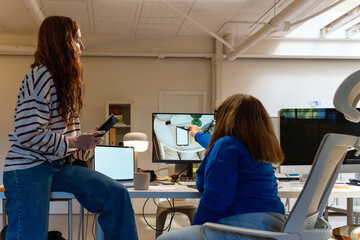 Coworkers sharing a moment at desk

