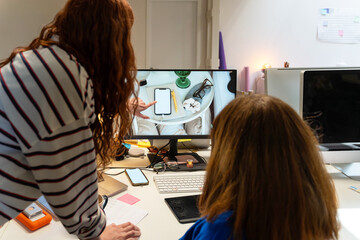 Coworkers sharing a moment at desk

