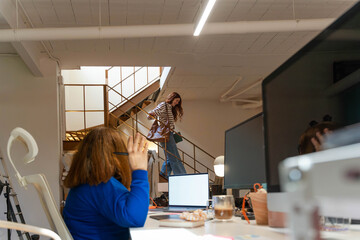 Waving hello in creative studio



