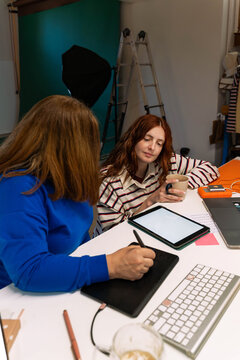 Team Working Late on Blank Tablet
