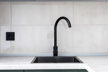 kitchen faucet on a stylish metal sink